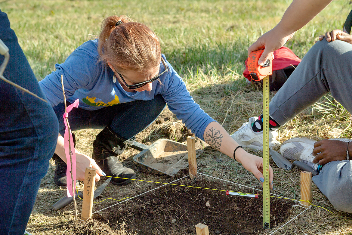 MTSU student Kathryn Miller measures the depth of an archaeology unit during an Oct. 19, 2019, dig at the Bass Street Community Archaeology Project in Nashville, Tenn. The site represents one of the first post-Civil War black neighborhoods in Nashville. (MTSU photo by James Cessna)