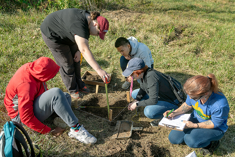 MTSU students measure an archaeology unit and document their work during an Oct. 19, 2019, dig at the Bass Street Community Archaeology Project in Nashville. Pictured, from left, are Julius King, Autumn Lovell, Lar May, Olivia Thompson and Kathryn Miller. (MTSU photo by James Cessna)