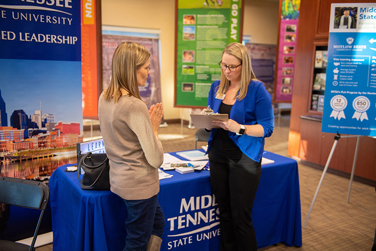 An MTSU University College staffer answers questions at a Finish Your Degree Q-and-A event for prospective students in late October at the Rutherford County Chamber of Commerce in Murfreesboro, Tenn. The college will hold a similar event Feb. 6 at the D.W. Wilson Community Center in Tullahoma. It is free and open to the public. (MTSU file photo by James Cessna)
