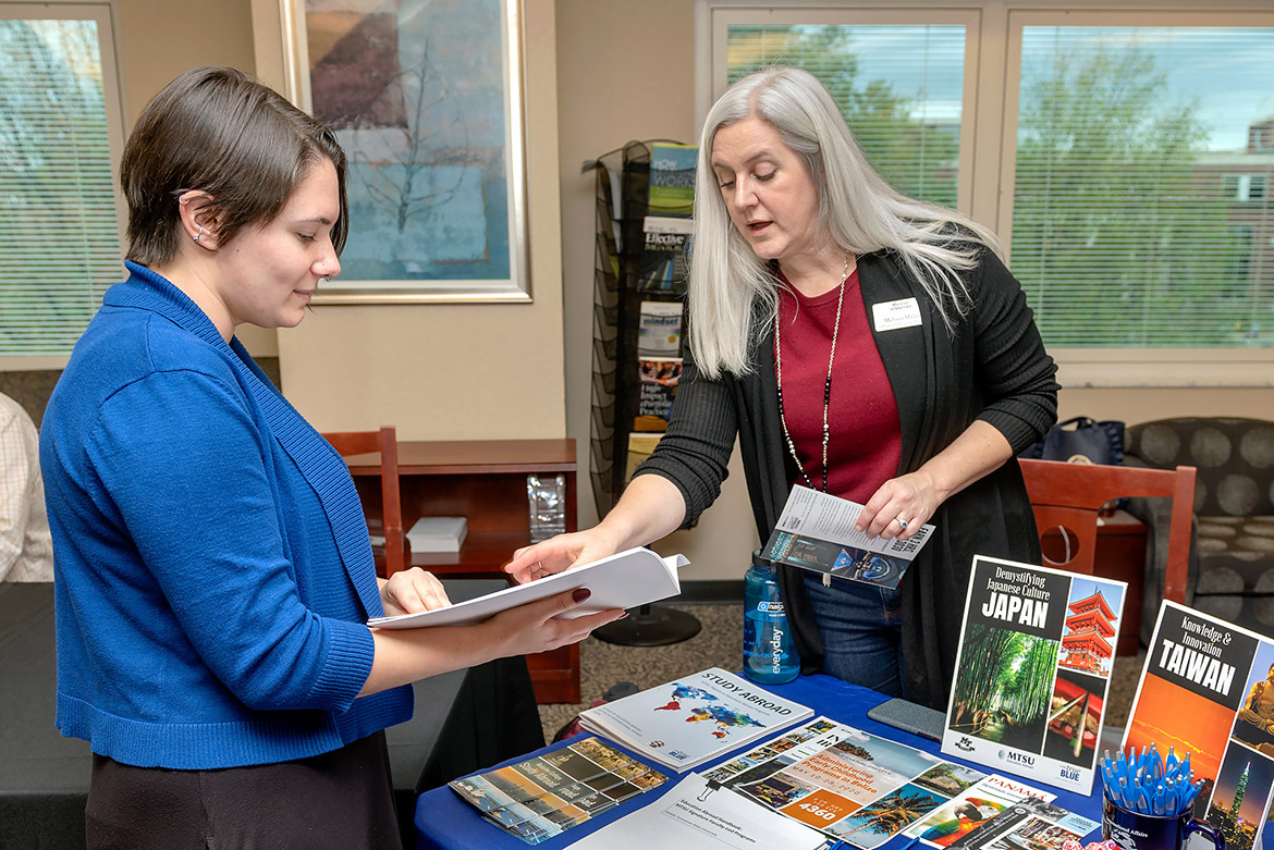 Melissa Miller, right, director of the Office of Education Abroad at MTSU, explains study-abroad courses to master's degree candidate Jeanette Stevens of the Career Development Center at the Learning, Teaching and Innovative Technology Center in October 2019. (MTSU file photo by James Cessna)