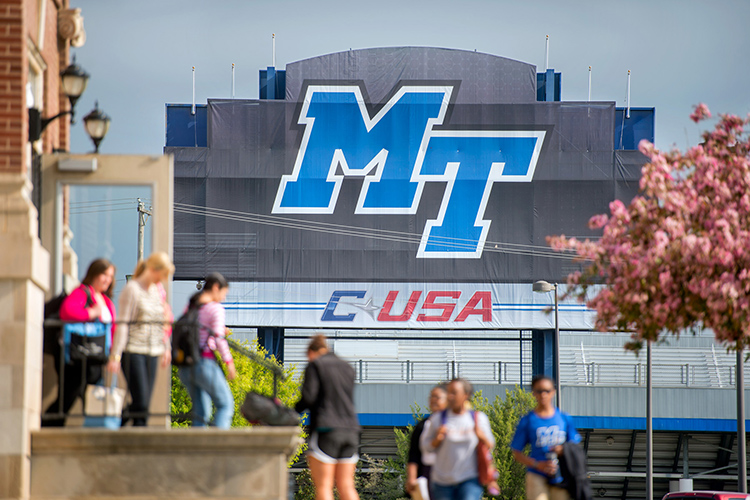With Floyd Stadium in the background, students enter and exit Kirksey Old Main in this file campus photo. An MTSU task force has released recommendations for bringing students back to campus for in-person classes in some capacity for the Fall 2020 semester. (MTSU file photo by J. Intintoli)