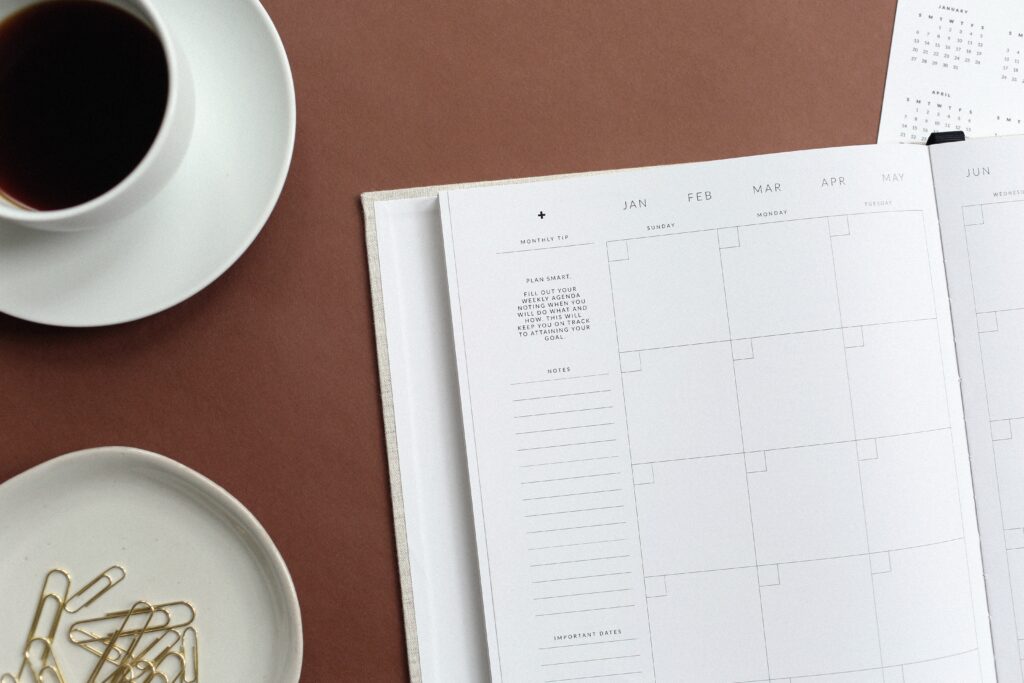 Planner on table. Photo by NORTHFOLK on Unsplash