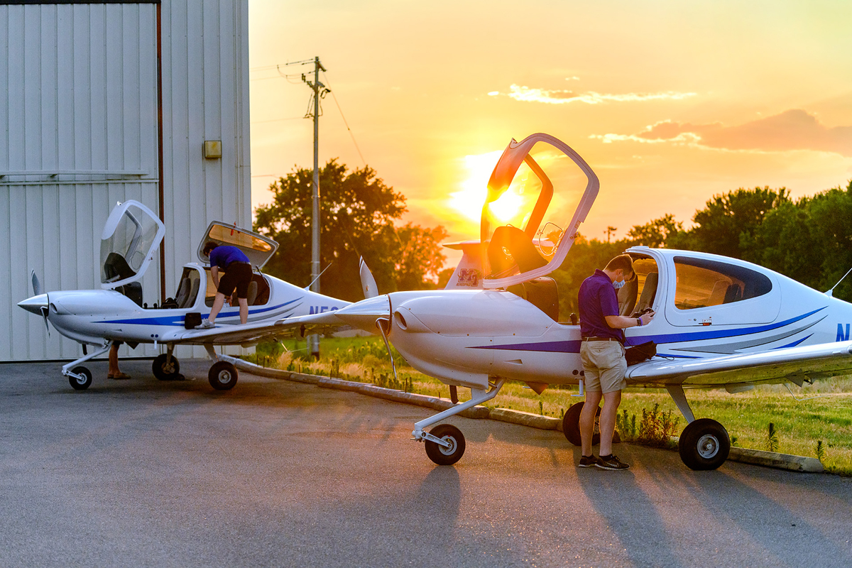 As sunset approaches, MTSU aerospace students and certified flight instructors Ryan Patterson, partially hidden left. Cole Ferraro and Copher Kashif perform their final checks and unloading after flying in two new Diamond Aircraft on Friday, June 19, from Michigan near the Canadian border. MTSU purchased six new planes and is having 13 planes refurbished. (MTSU photo by J. Intintoli)