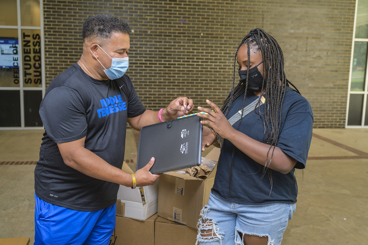Office of Student Success staff member Marvin Spencer, left, hands out gifts to Joy Griffin of Knoxville, Tenn., at Peck Hall recently following the end of this year’s virtual Freshmen Summer Institute. Nearly 100 freshmen participated, jump-starting their college careers. (MTSU photo by Andy Heidt)