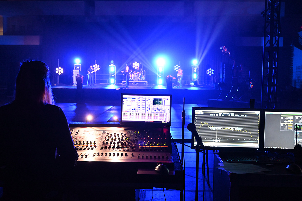 MTSU audio production alumna Ashley Mills, left, a West Virginia native who now lives in Franklin, Tenn., operates the soundboard during with the performance of indie rock/pop band Shelter Cove on Sept. 15 at Belmont University in Nashville, Tenn. The band, which includes MTSU students and alumni who perform on the university’s student-run label, Match Records, performed with artists from four other Nashville-area universities in “Rock the Vote at Belmont University: Nashville Colleges Celebrate Democracy” that aired Tuesday, Sept. 22. (MTSU photo by Frank Baird)