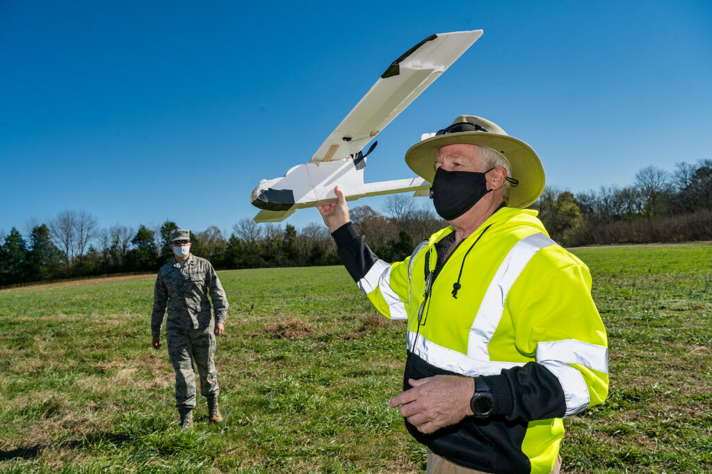 Kevin Corns, assistant professor in the Department of Aerospace, is shown with students flying their Unmanned Aircraft Systems drones at the MTSU Farm in Lascassas, Tenn. He said this is a fixed-wing drone they built in an upper-division UAS Operations program class. (MTSU photo by Andy Heidt)