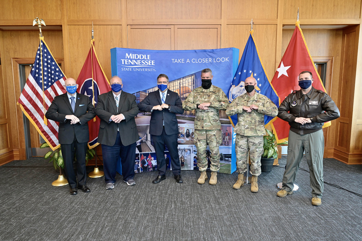MTSU’s Keith M. Huber, left, Bud Fischer, Mark Byrnes and Tennessee Adjutant General Jeff Holmes, assistant Adjutant General Jason Glass and Todd Wiles wrap up the agreement signing with an elbow bump Tuesday Nov. 3, in the President’s Executive Conference Room in the Student Union Building on campus. (MTSU file photo Andy Heidt)