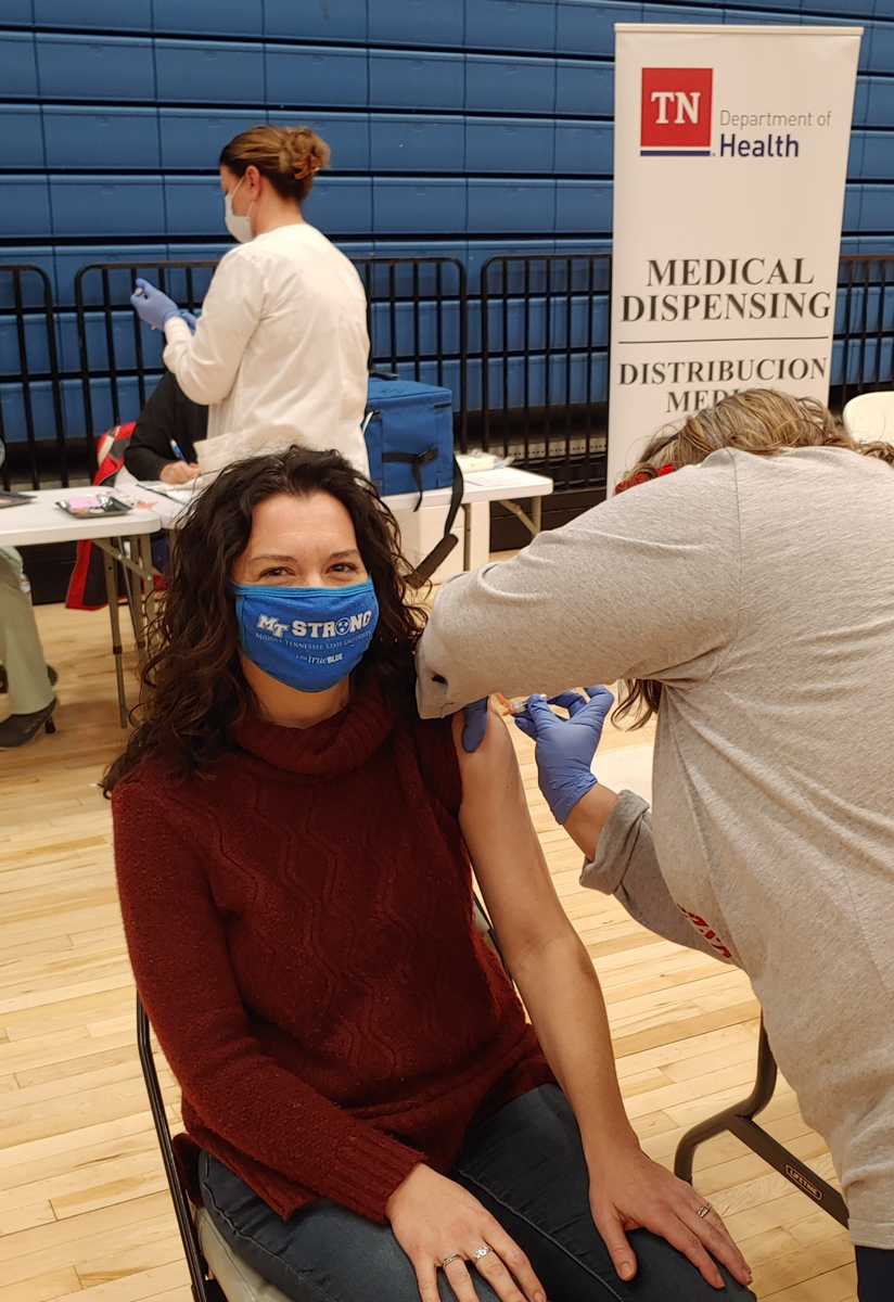 MTSU Health Promotion Director Lisa Schrader receives the Moderna vaccine Wednesday, Dec. 23, at the Siegel High School Gym in Murfreesboro. She was among 12 MTSU staff members and dozens of other health care workers and first responders in the area to receive the first round of the vaccine. (MTSU photo by Jason Schrader)