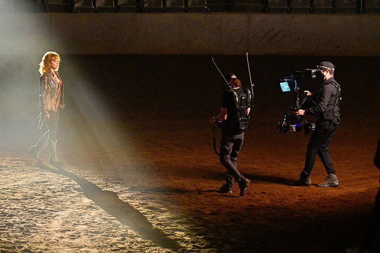 Country music legend Reba McEntire, left, walks toward director Shaun Silva, middle, and Tony Reyes, steady camera operator, right, during the music video shoot for her new single with Cody Johnson “Dear Rodeo.” Middle Tennessee State University alumni and students helped produce the video filmed at MTSU’s Tennessee Miller Coliseum in Murfreesboro, Tenn., on Oct. 1, 2020. (MTSU photo by Andy Heidt)