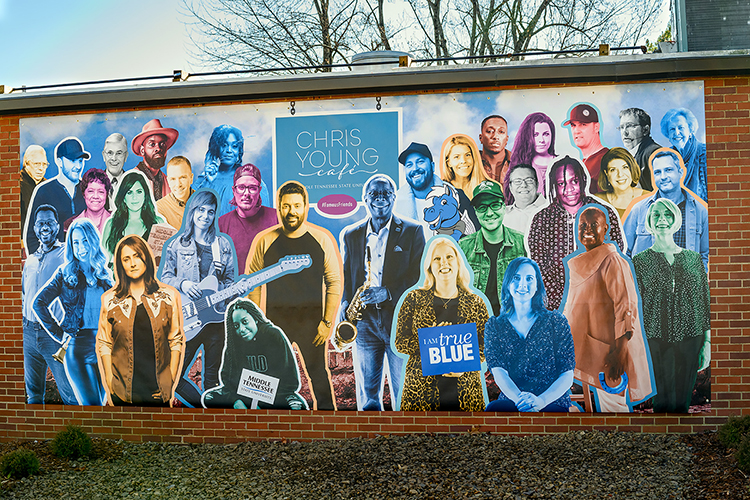 A colorful new mural on the north exterior wall of MTSU's Chris Young Cafe, officially opened in a special livestreamed ceremony Wednesday, Jan. 27, shows the multiplatinum country entertainer and Murfreesboro, Tenn., native at center left, flanked by MTSU President Sidney A. McPhee at center right, and more than two dozen MTSU-trained musicians and media members, educators and leaders from throughout the community. Leslie Haines, a professor of visual communication in the college’s School of Journalism and Strategic Media, and Jonathan Coulter Trundle, a professor of photography in the Department of Media Arts, designed the mural for the cafe, a 1963-era cafeteria refurbished into a teaching and rehearsal space and performance venue with help from a donation from Young. Click on the image for a PDF to identify each of the mural subjects and their MTSU connections. (MTSU photo by J. Intintoli)