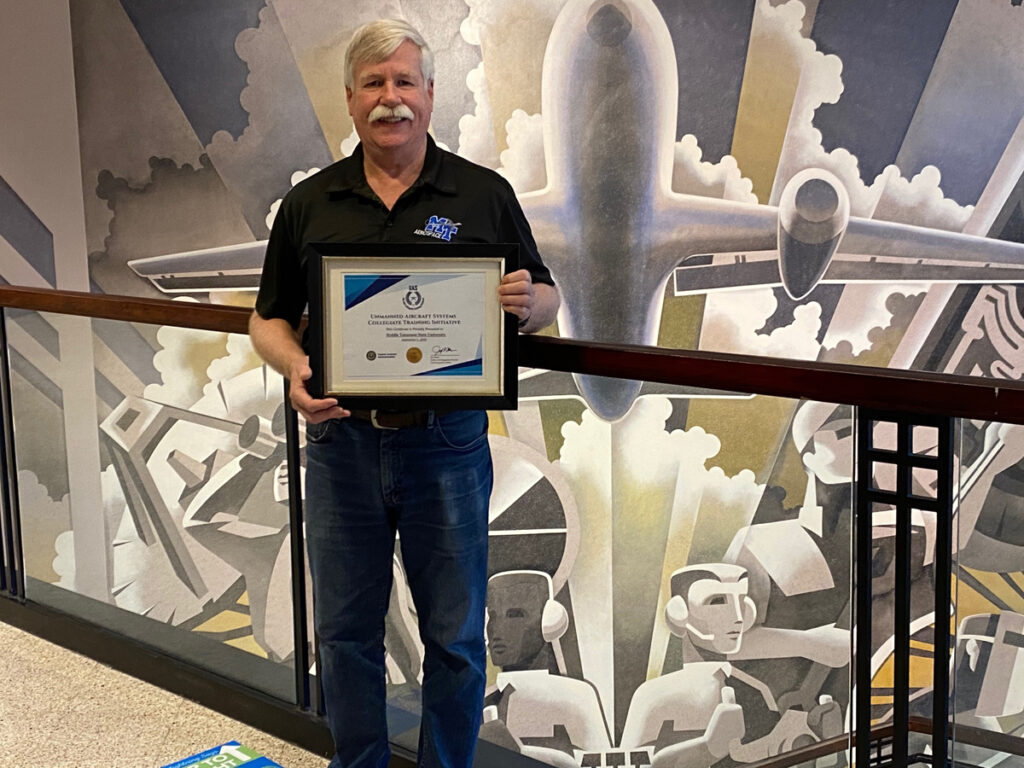 Kevin Corns, MTSU UAS Operations director and assistant professor in the Department of Aerospace, holds the certificate sent by the FAA, acknowledging the Collegiate Training Initiative program that the aerospace department is now a part of since September. The program recognizes institutions that prepare students for careers in unmanned aircraft systems, commonly called drones. (MTSU photo by Mary Lou Cornett)
