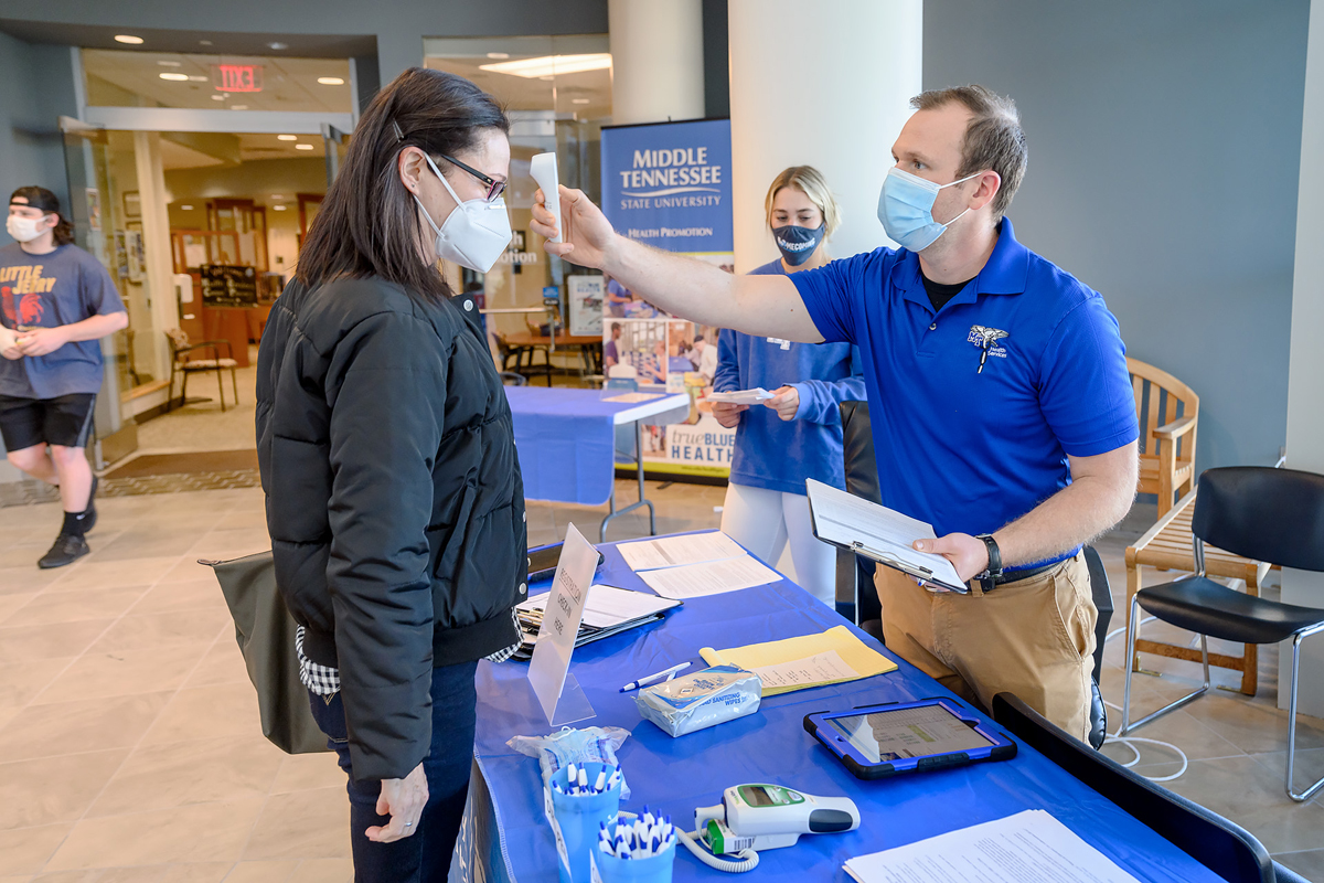 MTSU Murphy Center secretary Andrea Sakoff, left, is checked in by Vinny Black, right, health educator in Health Services, and student Summer Burgess, a contact tracer for Health Services, at the COVID-19 campus vaccine clinic this week in the Health, Wellness and Recreation Center. Vaccines are available, by appointment only, from 9 a.m. to 2:30 p.m. for MTSU faculty, staff, students, retirees and household members meeting current state guidelines. This clinic is operated independently from the community vaccination clinic hosted by the School of Nursing in the Cason-Kennedy Nursing Building. (MTSU photo by J. Intintoli)