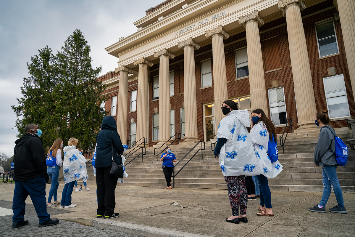 MTSU Blue Elite student tour guide Miura Rempis, center, talks to visitors on a recent in-person daily campus tour about Kirksey Old Main, the longtime home of the Computer Science and Mathematical Science departments. Prospective students and their guests practice social distancing, wear masks and adhere to other COVID-19 safety protocols. (MTSU photo by Andy Heidt)