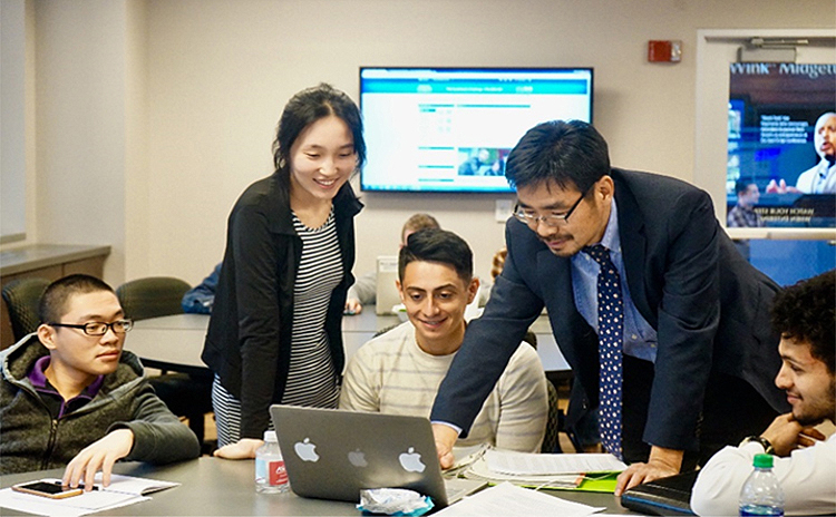 MTSU Economics and Finance professor Kevin Zhao, standing at right, advises students in his Spring 2018 TVA Investment Challenge class inside the Business and Aerospace Building. The annual competition allows college students from universities throughout the region an opportunity to manage a real stock portfolio to hone their analytical skills. (Submitted photo)