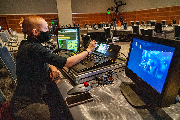 Erin Featherston, a senior theater major from Powell, Tennessee, makes adjustments to the lighting during setup Wednesday, March 24, for the Briston Maroney concert in MTSU's Student Union ballroom. Featherston, whose minor is in entertainment technology, was one of nearly 50 students from two different colleges — and three departments — who collaborated to present MTSU's first in-person, large-scale "Signature Event" since 2019. (MTSU photo by Andy Heidt)