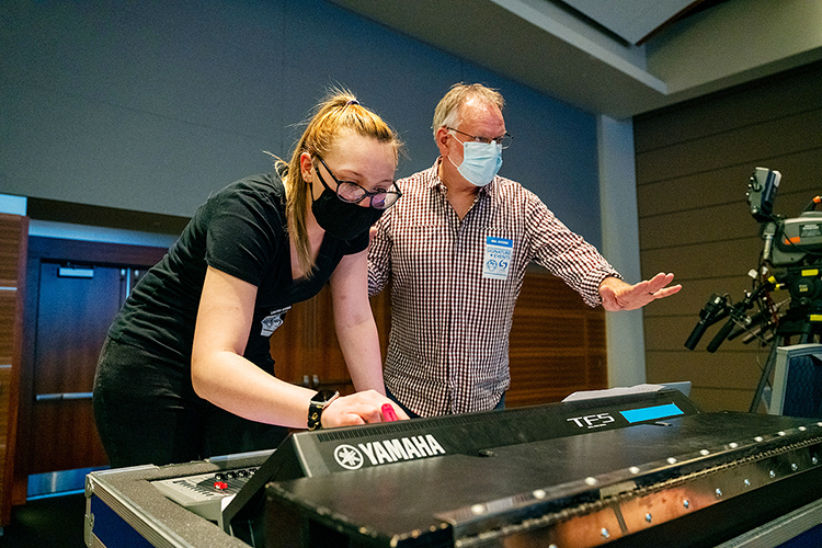 Sam Hopewell, left, a senior audio production major from Rockford, Illinois, works on the mixing board while Department of Recording Industry professor Frank Baird gestures to another crew member on stage during setup Wednesday, March 24, for the Briston Maroney concert in MTSU's Student Union ballroom. Hopewell, whose minor is in theatre, was one of nearly 50 students from two different colleges — and three departments — who collaborated to present MTSU's first in-person, large-scale "Signature Event" since 2019. (MTSU photo by Andy Heidt)