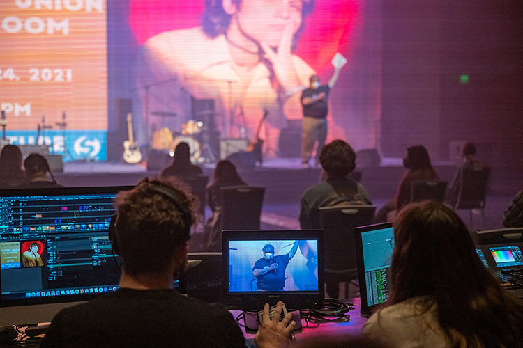 Department of Media Arts students in MTSU's media technology course monitor the video wall Wednesday, March 24, while Richard Kershaw, director of MTSU’s Student Programming and Raider Entertainment Office, is shown onscreen emceeing the Briston Maroney "Signature Events" concert in the Student Union ballroom. Nearly 50 students from two different colleges — and three departments — collaborated to present MTSU's first in-person, large-scale "Signature Event" since 2019. (MTSU photo by Cat Curtis Murphy)