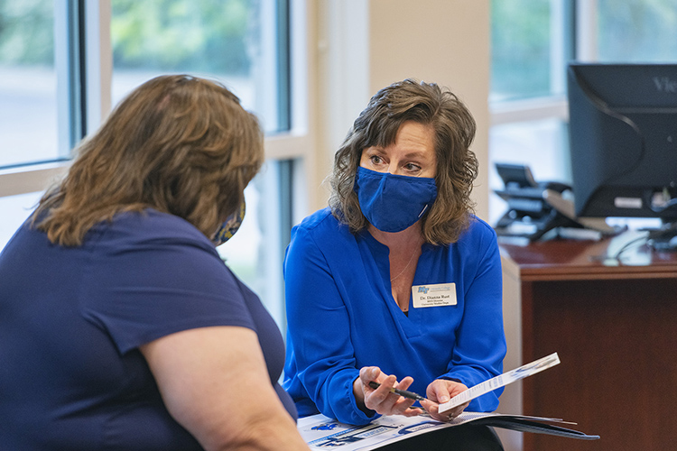 Dr. Dianna Rust, a professor of University Studies, talks to a prospective student at the April 13 Finish Your Degree Q&A event held at the Rutherford County Chamber of Commerce. MTSU University College representatives met with working adults to discuss completing unfinished degrees. (MTSU photo by Cat Curtis Murphy)