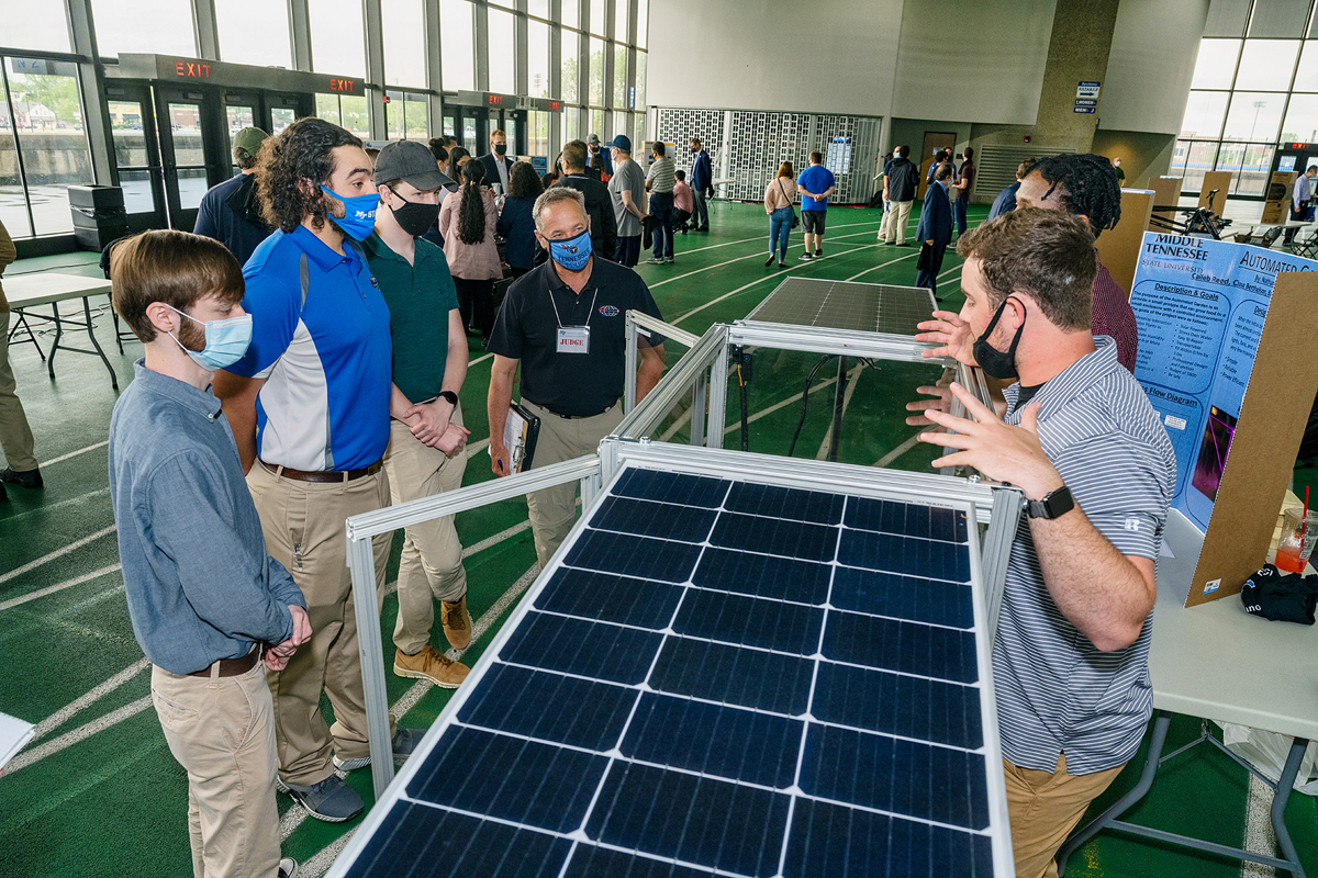 MTSU seniors Caileb Reed, right, of Chattanooga, Tenn., and Barry Andreti, second from right, of Birmingham, Ala., explain their Automated Garden project while seniors Chase Berthelson, left, of Arlington, Tenn., Jacob Hendrixson of Murfreesboro, Tenn., Derek Lipinski of Erie, Pa., and event judge, MTSU alumnus and Murfreesboro businessman Jimmy Davis listen Thursday, April 29, during the Mech-Tech Expo featuring Engineering Technology students and their senior projects on the Murphy Center track level. (MTSU photo by Andy Heidt)