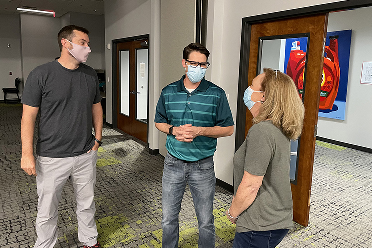 Ryan Otter, left, co-director of the MTSU Data Science Institute, and MTSU student Beverly Meadows, right, chat with MTSU alumnus David Tinsley, director of information systems and information technology at Second Harvest Food Bank of Middle Tennessee, on April 11 as part of a field trip by the inaugural cohort in MTSU’s data science graduate certificate program to Second Harvest’s warehouse location in Nashville, Tenn. Second Harvest provided the group access to some of its databases as part of the students’ final class project. (MTSU photo by Charlie Apigian)