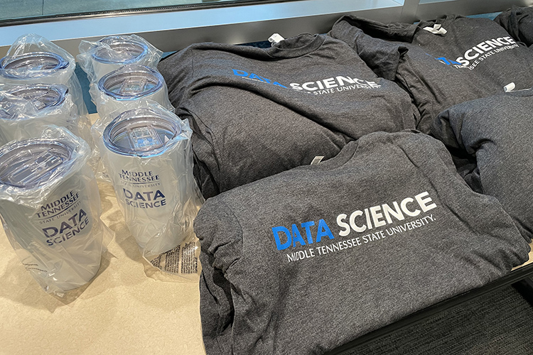 MTSU Data Science travel mugs and T-shirts on display at Second Harvest Food Bank of Middle Tennessee. (MTSU photo by Charlie Apigian)