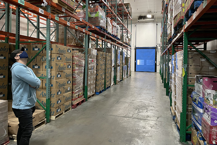 MTSU alumnus Vince Herbert, one of the students in the first cohort for MTSU’s new graduate certificate program in data science, inspects inventory during an April 11 field trip by the cohort to Second Harvest’s warehouse location in Nashville, Tenn. Second Harvest provided the group access to some of its databases as part of the students’ final class project. (MTSU photo by Charlie Apigian)
