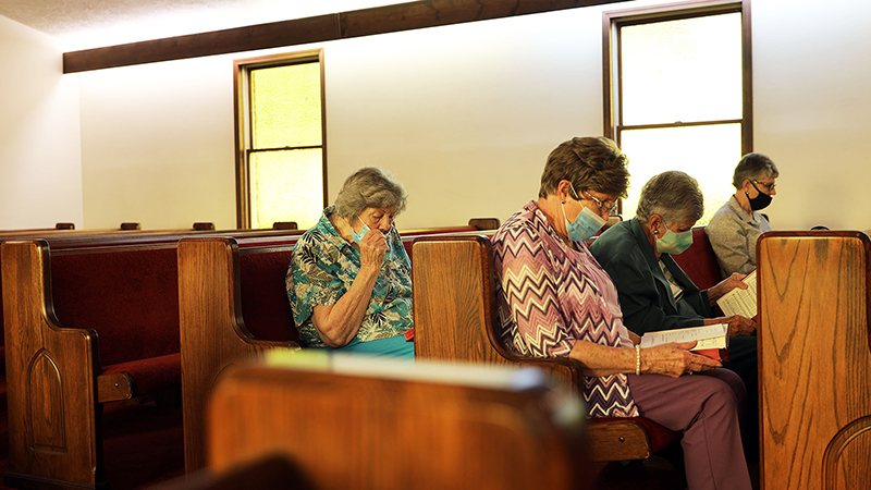 The four members of Tate’s Chapel United Methodist Church in Chilhowie, Va., study their hymnals during a May 23 church service. The tiny congregation, reduced to four by years of relocations, retirements and deaths, received an unexpected $700,000 windfall from a former member’s estate this year to do good works. Students from MTSU journalism professor Leon Alligood's summer 2021 “Road Trip” feature writing class trip to Bristol, Tenn., were the first to report on the church's news. (photo courtesy of Jordan Cobbs)