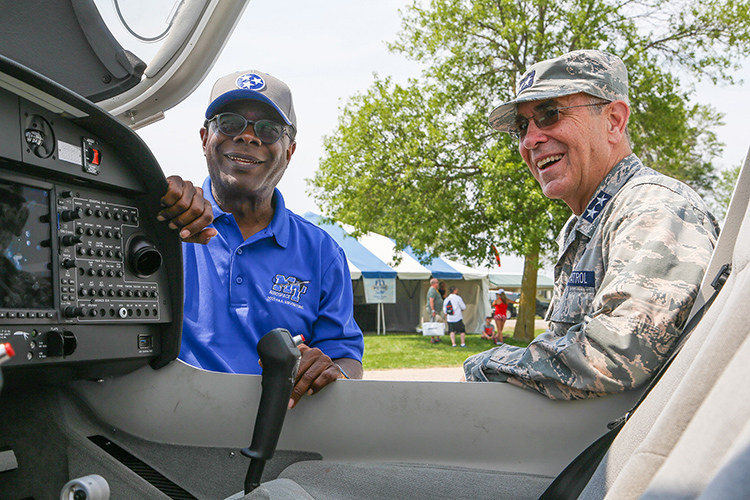 Middle Tennessee State University President Sidney A. McPhee, left, and Maj. Gen. Mark Smith, Civil Air Patrol’s national commander and chief executive officer, inspect one of the university’s Diamond Aircraft Monday, July 26, on the grounds of the EAA AirVenture 2021 in Oshkosh, Wisc. MTSU and CAP signed a three-year extension of their partnership just hours after the Experimental Aircraft Association’s signature annual event roared back after a one-year COVID-19 hiatus. (U.S. Air Force Auxiliary photo by Lt. Col. Robert Bowden)