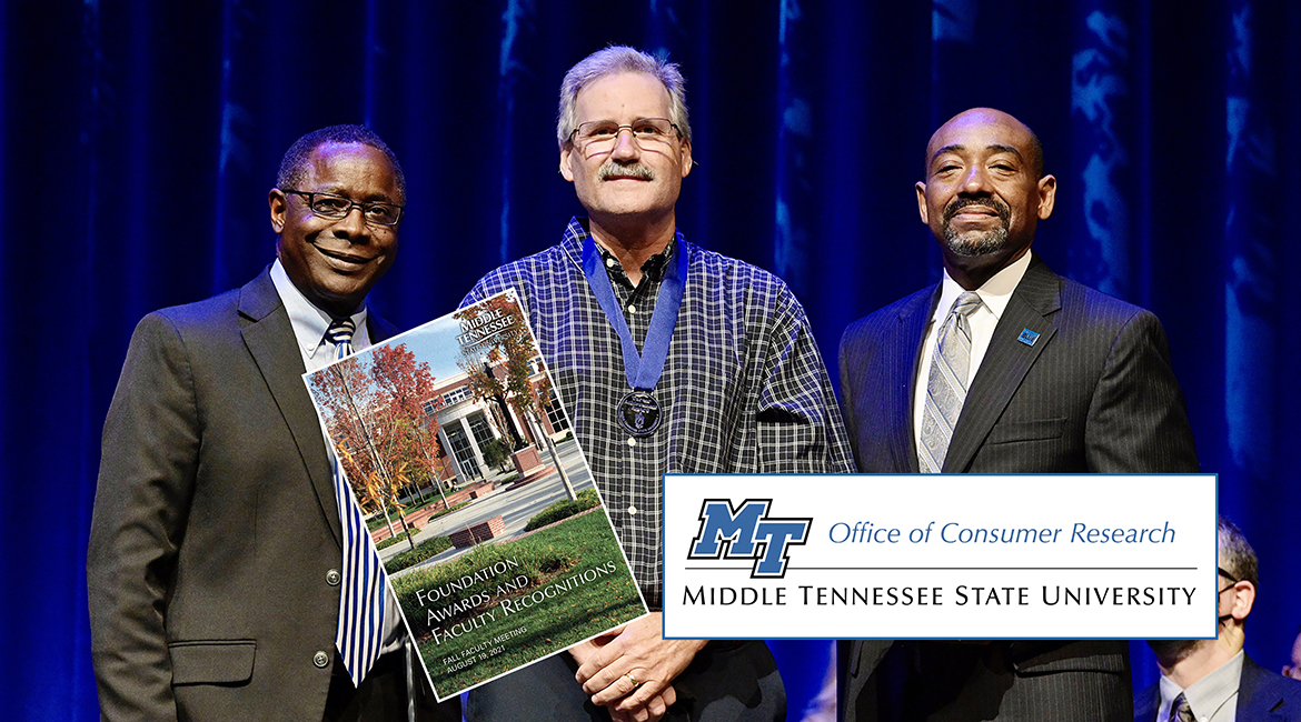 MTSU marketing professor Timothy Graeff, center, proudly wears his new Career Achievement Award medallion Thursday, Aug. 19, after receiving the university's top teaching honor from President Sidney A. McPhee, left, and alumnus Ronald Roberts, vice president of the MTSU Foundation in Tucker Theatre during the 2021 Fall Faculty Meeting. Graeff also is founder of MTSU’s Office of Consumer Research. Ten more MTSU professors also were recognized by the MTSU Foundation with awards for their for their accomplishments in and outside the classroom, and McPhee presented his 2021 State of the University address during the gathering. (MTSU photo by Andy Heidt)
