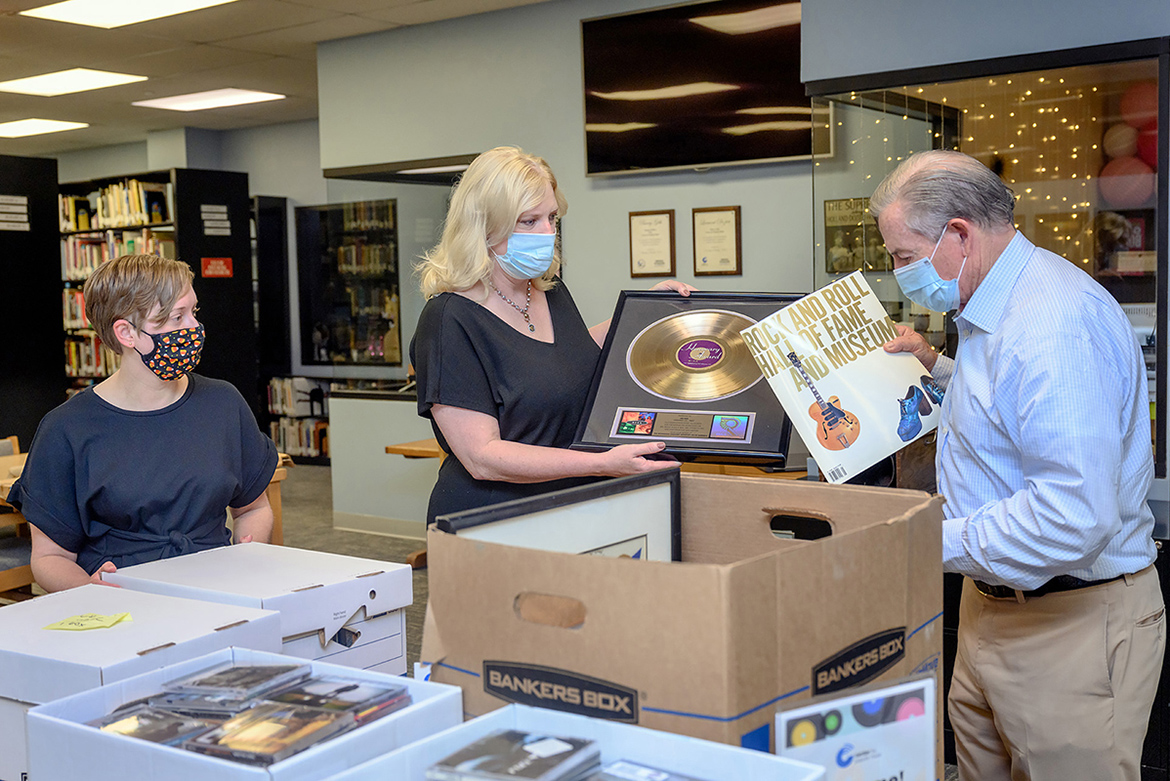 MTSU alumnus Jim Free, right, a member of the Country Music Association board, shows the musical memorabilia he collected from his decades in show business to archivist Rachel Morris, left, and Beverly Keel, dean of the College of Media and Entertainment on Monday, Aug. 16, inside the Center for Popular Music in the university's Bragg Building. Free donated ticket stubs, event programs, and other artifacts to the CPM. (MTSU Photo by J. Intintoli)