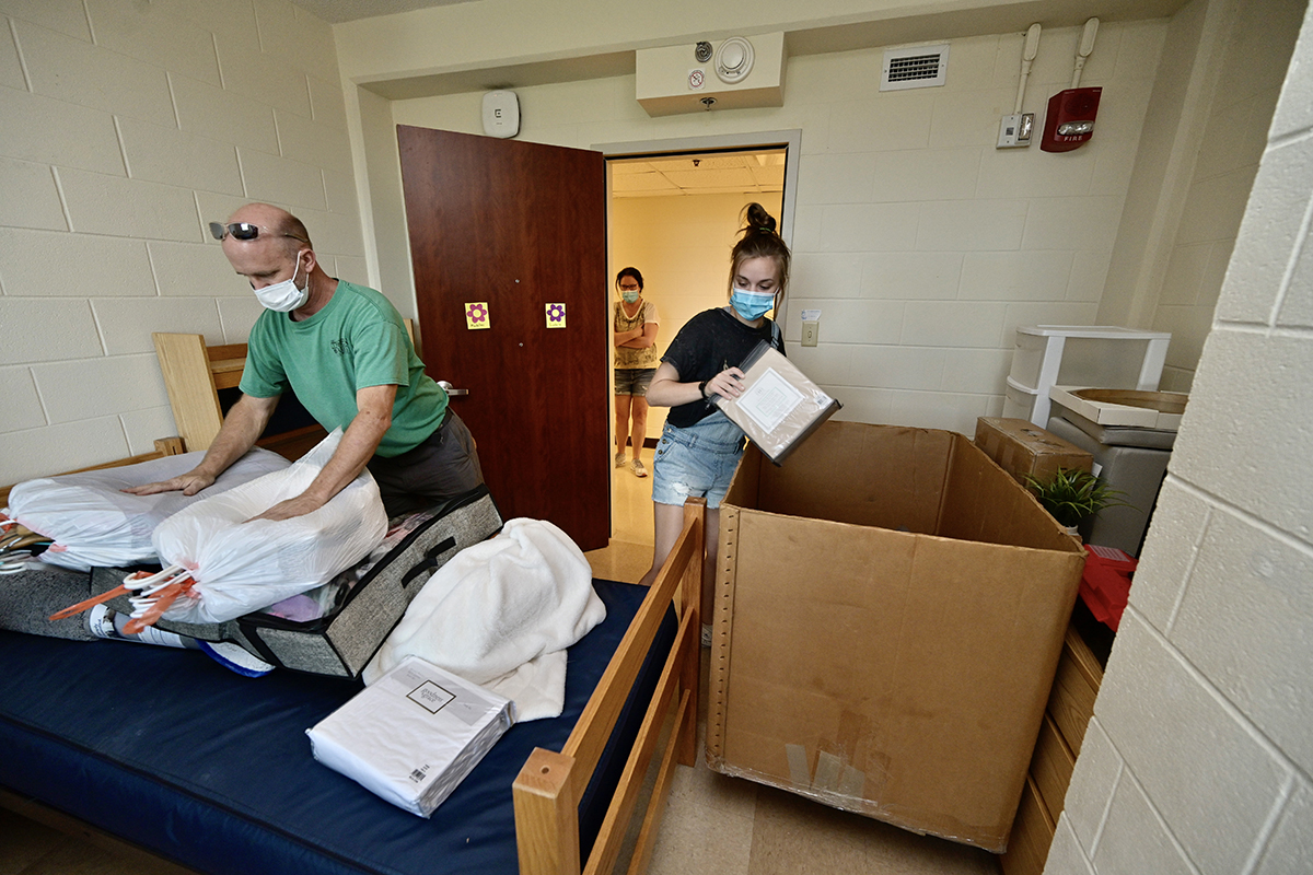 Isabella Campbell, right, an MTSU freshman from Franklin, Tenn., and her father Russ Campbell take items out of a large container used to haul her personal belongings in her Corlew Hall room earlier this week, as her mother, Andrea, waits. Isabella Campbell will major in English and international relations and minor in Portuguese and Spanish. Nearly 3,000 students will be moving into campus housing. (MTSU photo by Andy Heidt)