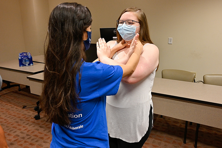 Middle Tennessee State University students Gaby Jaimes, left, and Savannah Winegar train blocking a choke during the free self-defense course Rape Aggression Defense Systems, or RAD, on Sept. 7, 2021. (MTSU photo by Stephanie Barrette)
