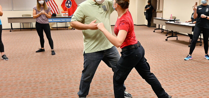Jason Hurley, Middle Tennessee State University training sergeant, models deflecting an attack with Katelynn Erskine, MTSU police officer, as part of the self-defense course Rape Aggression Defense Systems, or RAD, offered free of charge on Sept. 7, 2021. (MTSU photo by Stephanie Barrette)