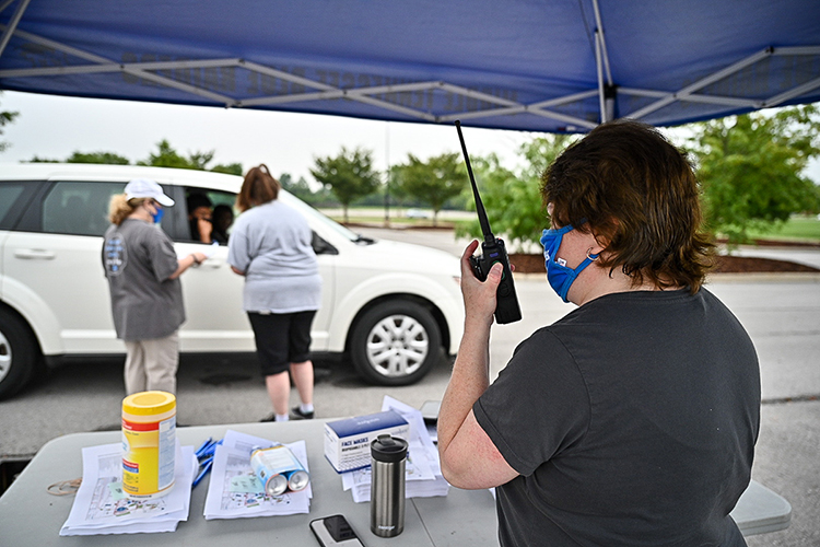 Carol Cuff of MTSU Housing and Residential Life checks in with colleagues by radio in this August 2020 file photo while housing director Michelle Safewright, left, and secretary April Branson talk with a student picking up a parking permit for the new academic year in a special drive-through checkpoint. Students are moving into MTSU dorms for the 2021-22 academic year through Aug. 21 by individual appointment again to help maintain health safety conditions. The university's Parking and Transportation Services is joining the move-in checkpoint line — and repeating its drive-through permit pickup for all students Aug. 23-25 — to make the process more efficient. (MTSU file photo by J. Intintoli)