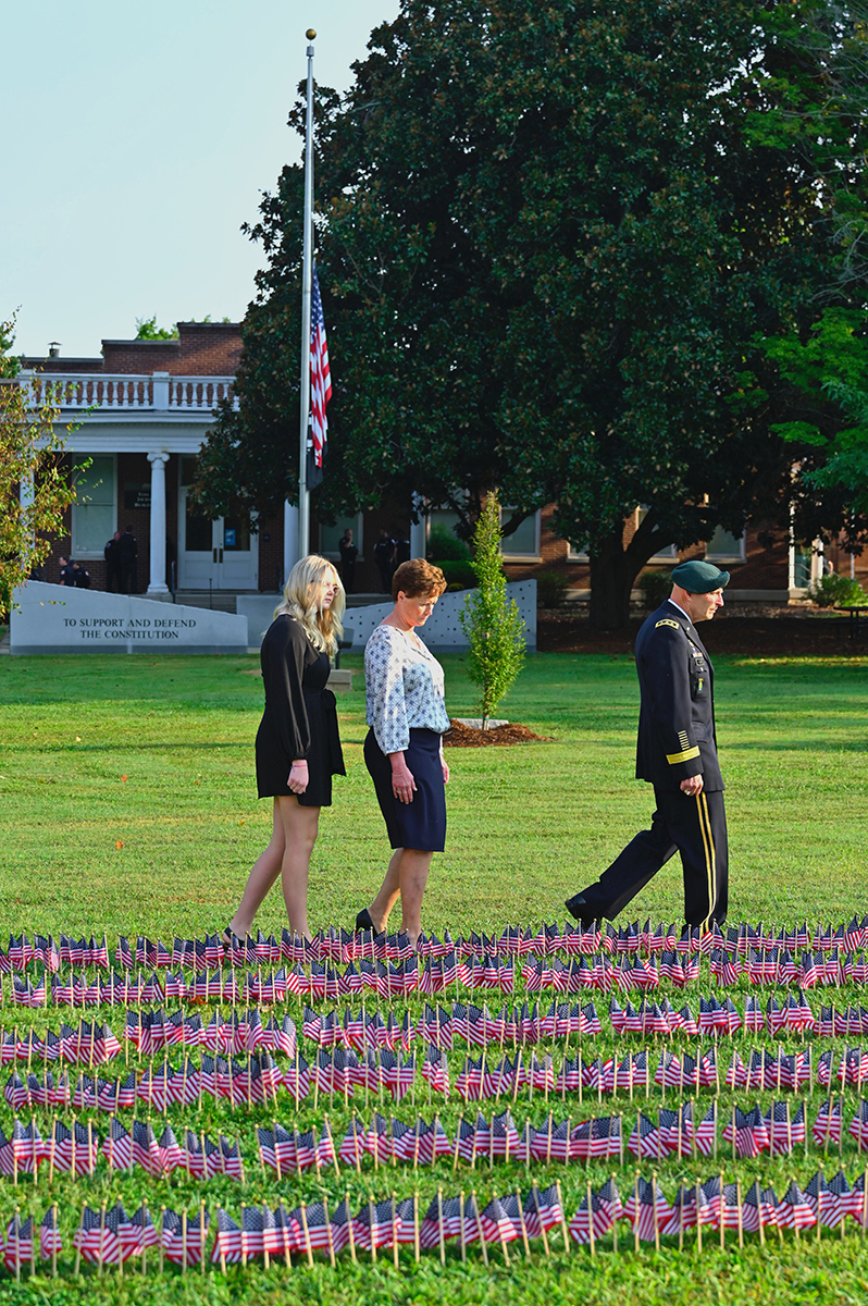 Retired U.S. Army Lt. Gen. Keith M. Huber, right, MTSU senior adviser for veterans and leadership initiatives, his wife Shelly and their daughter Alexis walk through the field of U.S. flags Saturday, Sept. 11, near the MTSU Veterans Memorial. MTSU ROTC cadets placed 2,977 flags — each one representing a casualty from the Sept. 11, 2001 attack by the terrorist group al-Qaida — on Friday, Sept. 10. (MTSU photo by Cat Curtis Murphy)