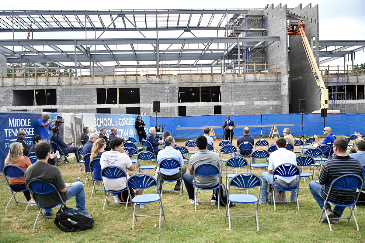 With the building in the background, MTSU President Sidney A. McPhee welcomes the crowd, praises the contributors and supporters of the the School of Concrete and Construction Management building during the topping-out ceremony Tuesday, Sept. 14, near the construction site. Work is ahead of schedule and is set to be completed in time for fall 2022 classes. (MTSU photo by J. Intintoli)
