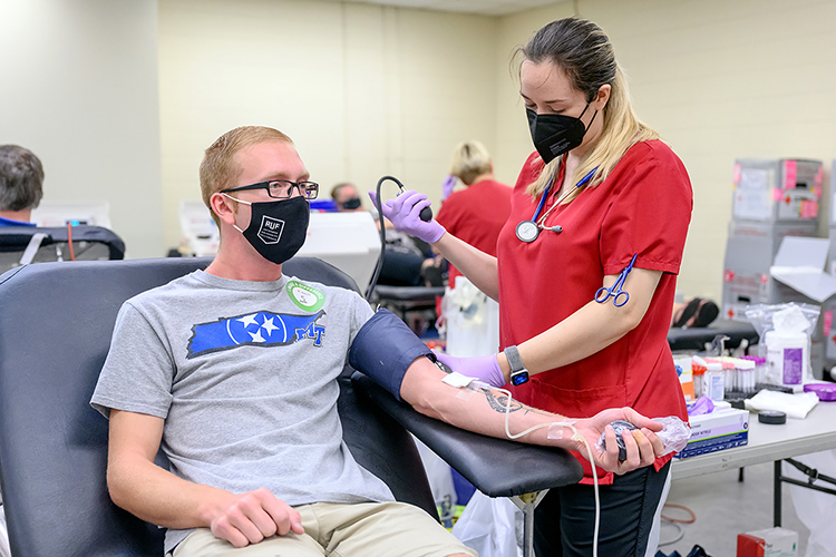 MTSU senior aerospace major Jeremy Lankford of Gallatin, Tenn., left, waits quietly while American Red Cross phlebotomist Kelsie Manuel checks his blood pressure before his blood donation process begins during MTSU's “Battle of the Branches” blood drive Sept. 2 in the Keathley University Center. Lankford and anyone else who gave blood before Labor Day is eligible to donate when MTSU's 2021 "True Blue Blood Drive" returns to campus Monday-Wednesday, Nov. 1-3, in the Student Health, Wellness and Recreation Center at 1848 Blue Raider Drive. (MTSU file photo by J. Intintoli)