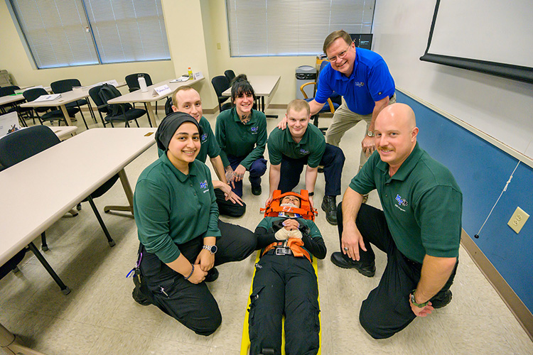 Middle Tennessee State University Advanced EMT instructor Randy White, top right, is shown with EMT students, from left, Morsell Durani, Chandler Mangrum, Makenna Stark, Cale Brown, Andrew Hill, and Claudia Tepox (on stretcher) inside a classroom at the Miller Education Center on Bell Street. (MTSU photo by Andy Heidt)