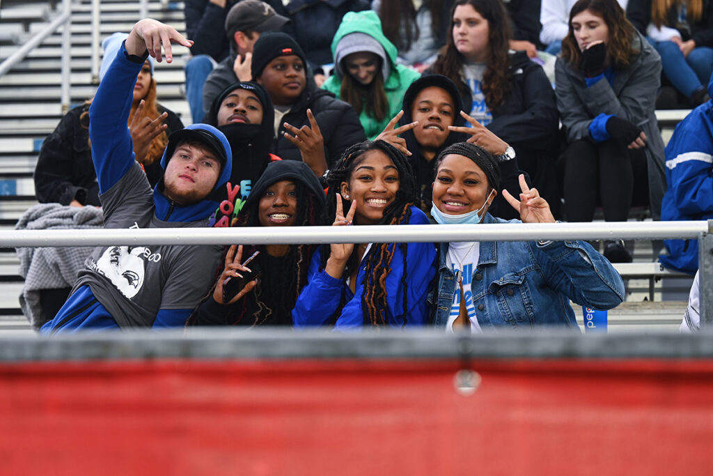 MTSU students walk with their float they created for the 2021 Homecoming Parade down Middle Tennessee Boulevard in fron of The Alumni House. Rain did not dampen the spirits of those attending the annual event, held in-person after a one-year break because of COVID-19. (MTSU photo by J. Intintoli)