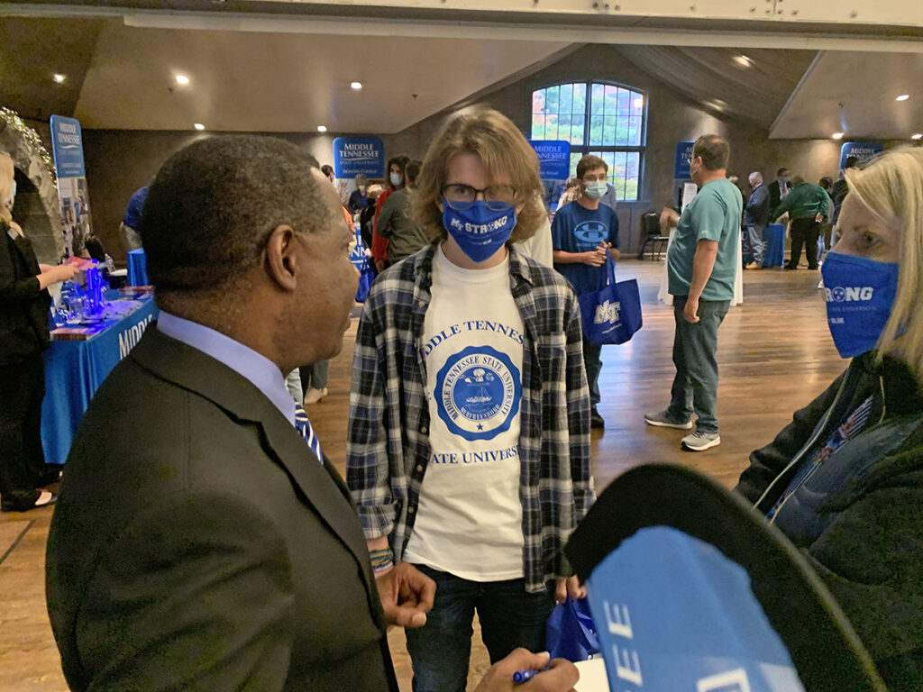 MTSU President Sidney A. McPhee, left, learns how interested Matthew Hart of Morristown, Tenn., is in the university and its mechatronics engineering program. Hart and his mother, Lori, visited the MTSU True Blue Tour event recently in Knoxville, Tenn. On Oct. 27, the Morristown West senior and his father, Duane, attended the tour event in Johnson City, Tenn. (MTSU photo by Randy Weiler)
