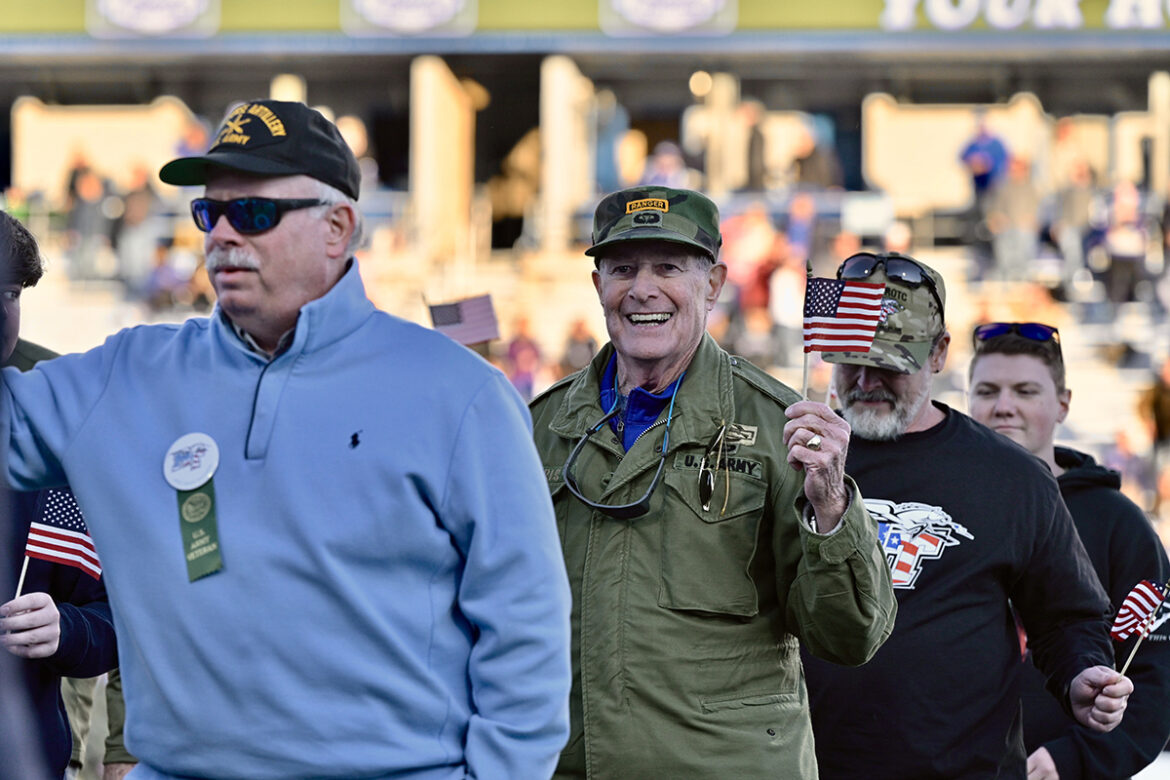 As the MTSU Band of Blue performs the U.S. Army theme, MTSU alumnus and Murfreesboro businessman Bud Morris, second from left, walks across Horace Jones Field at halftime with his fellow Army veterans during the university's 39th annual Salute to Veterans and Armed Forces activities Saturday, Nov. 13. The MTSU Band of Blue plays theme songs for all five of the military branches. (MTSU photo by Andy Heidt)