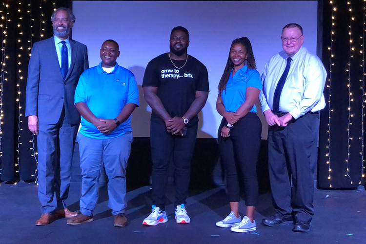 Family therapist and mental health coach Jay Barnett, center, poses for a photo with MTSU staff following his keynote in August to Scholars Academy participants and their parents inside Keathley University Center. Pictured, from left, are Vincent Windrow, associate vice provost for student success; Travis Strattion, assistant manager of the Scholars Academy; Barnett; Brelinda Johnson, Scholars Academy manager; and Rick Sluder, vice provost for student success. (Submitted photo)