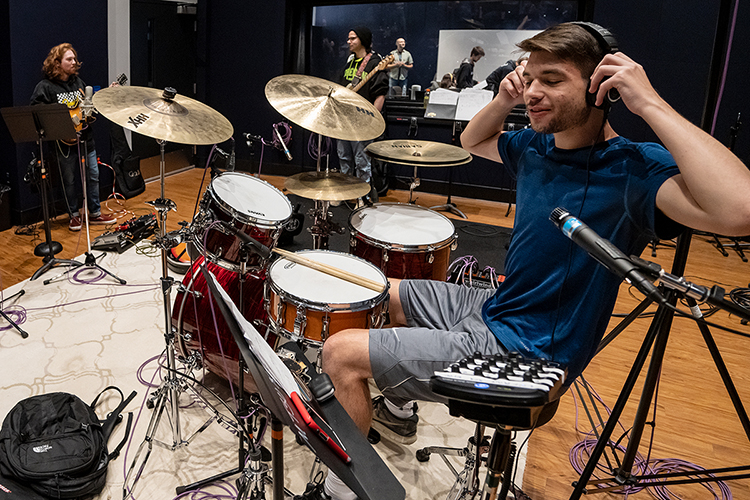 Clay Skiles, a senior audio production and mathematical sciences double major from Cypress, Texas, adjusts his headphones between recording sessions during one of this fall's “Studio Saturdays" for MTSU School of Music and Department of Recording Industry students in Studio D in the brand-new Main Street Studios facility. Pausing with him are fellow Commercial Music Ensemble members and audio production majors Josh Garner, left, a sophomore from Macon, Ga., and freshman Jacob Williams of Mt. Juliet, Tenn. (MTSU photo by Cat Curtis Murphy)