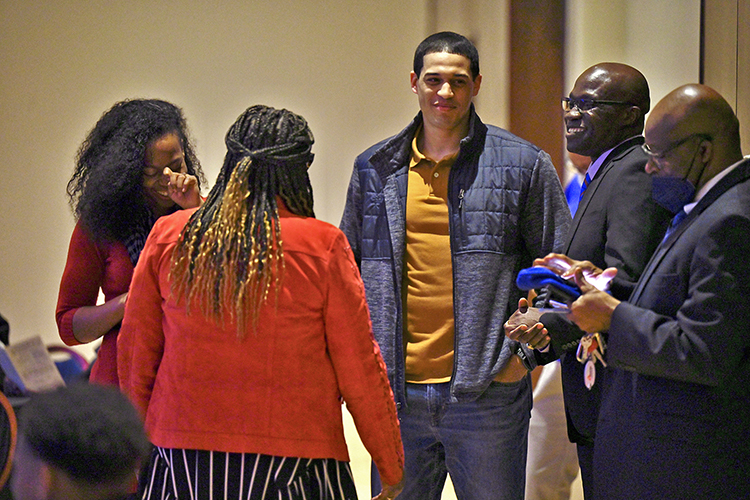 Dr. Andrew Owusu, professor of health and human performance, second from right, accepts congratulations from well-wishers at the 2022 John Pleas Faculty Award ceremony held Feb. 23 in the James Union Building at MTSU. (MTSU photo by Cat Curtis Murphy)