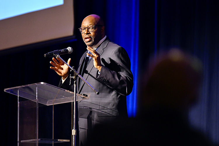MTSU Assistant Track and Field Coach Raymond Bonner praises Dr. Andrew Owusu, professor of health and human performance and the 2022 John Pleas Faculty Award recipient, during the Feb. 23 award ceremony in James Union Building. (MTSU photo by Cat Curtis Murphy)