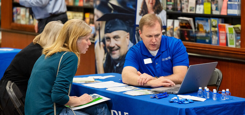 MTSU University College Advising Manager Rodney Robbins, right, speaks to prospective students at a Finish Your Degree Q and A event held in March at the Rutherford County Chamber of Commerce. University College is hosting another drop-in Q and A event on May 17 at Williamson Inc. in Franklin, Tenn. (MTSU file photo by James Cessna)