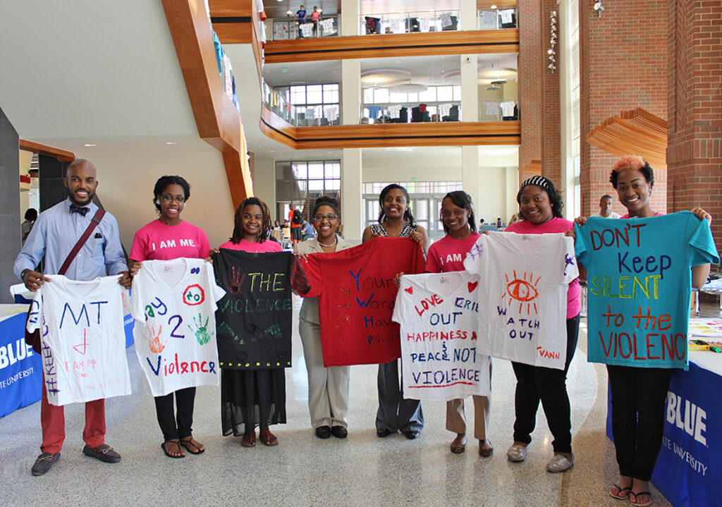 Participants a previous Clothesline Project display T-shirts bearing Sexual Assault Awareness Month messages in the Student Union atrium. Other T-shirts hang from the rafters overhead. The 2024 Clothesline Project will be on display Monday-Friday, April 1-5. (MTSU file photo)