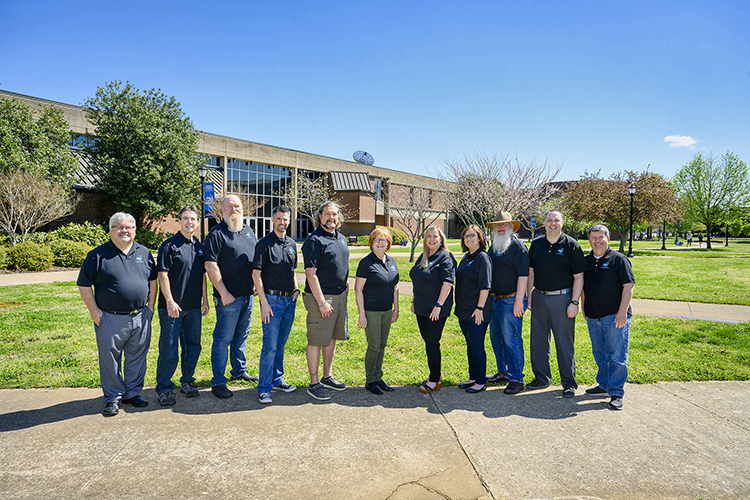 Staff from Middle Tennessee State University’s Center for Educational Media recently launched free professional development for Tennessee special education teachers, the third of their available education support training. Standing, from left, are CEM staff members Mitch Pryor, James Preston, Ronald Gilley, Jon Jackson, Charlie Scudder, Director Laura Clark, Jenny Marsh, Janet Dutton, Jeffery Nokes, Steven James and John Lanza outside of the Learning Resource Center on April 14, 2022. (MTSU photo by J. Intintoli)