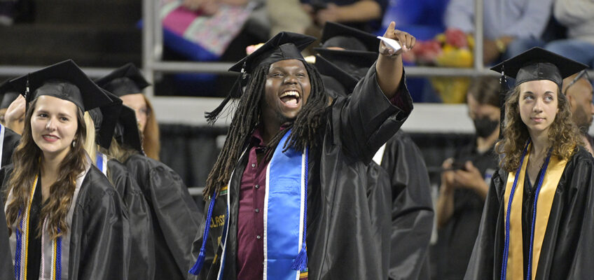Three Middle Tennessee State University prospective graduates wait to walk across the stage and accept their new degrees in Hale/Earle Arena inside Murphy Center Saturday, May 7, during the university's spring 2022 afternoon commencement ceremony. MTSU awarded 2,474 degrees — 2,041 to undergraduates and 433 to graduate students — during its three-ceremony spring 2022 commencement event. (MTSU photo by Andy Heidt)