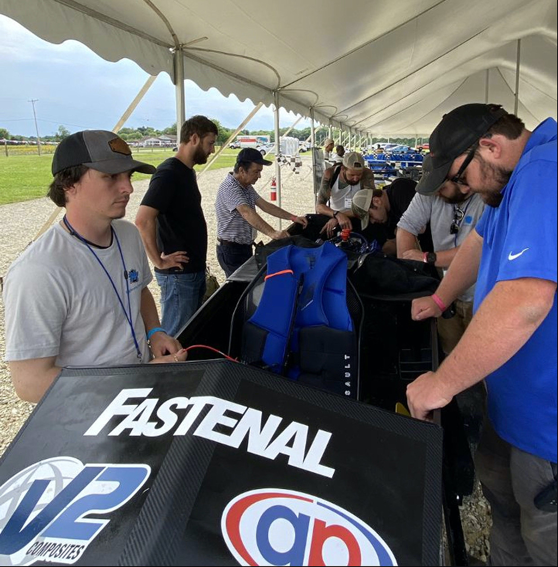 MTSU solar boat team members Hunter McMath, left, of Hohenwald, Tenn., Tyler Burns of Murfreesboro, Tenn., and others consider swapping motors on their watercraft recently during the annual Solar Splash event in Springfield, Ohio. The issue with the motor eventually was resolved, and the team placed fourth overall in the competition. (Submitted photo)